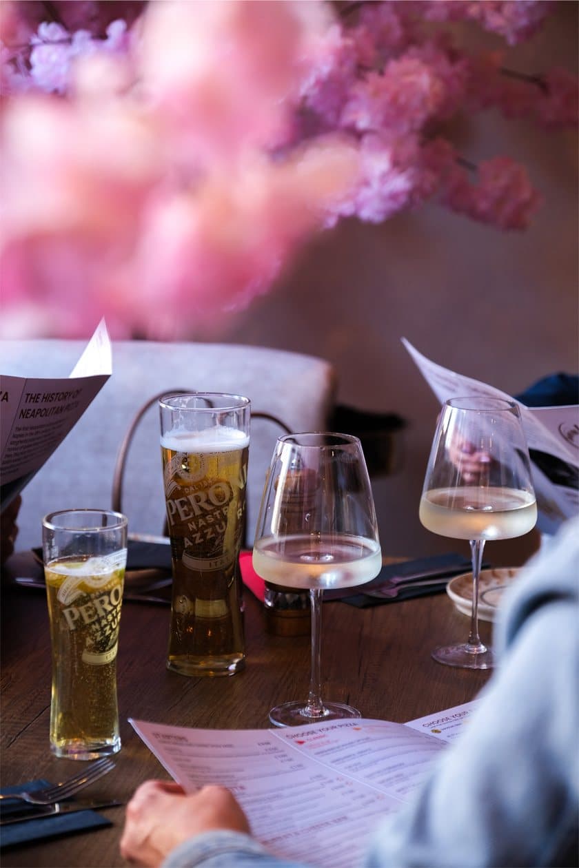 Drinks on the table beneath the blossom installation